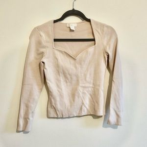 Cream colored sweetheart neckline knit top